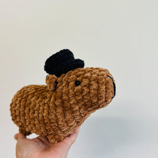 crochet capybara wearing a black crochet hat