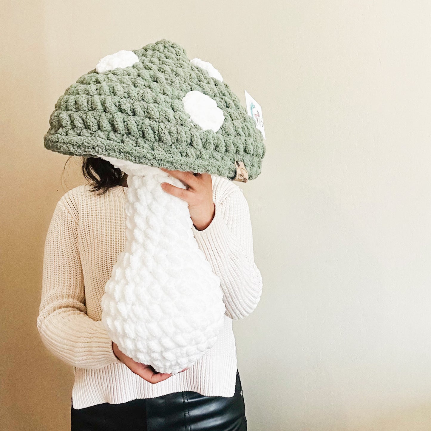 green mushroom pillow hold by a person