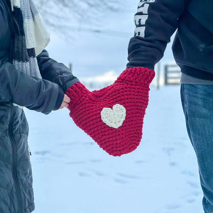 couples wearing a heart shape mitten 