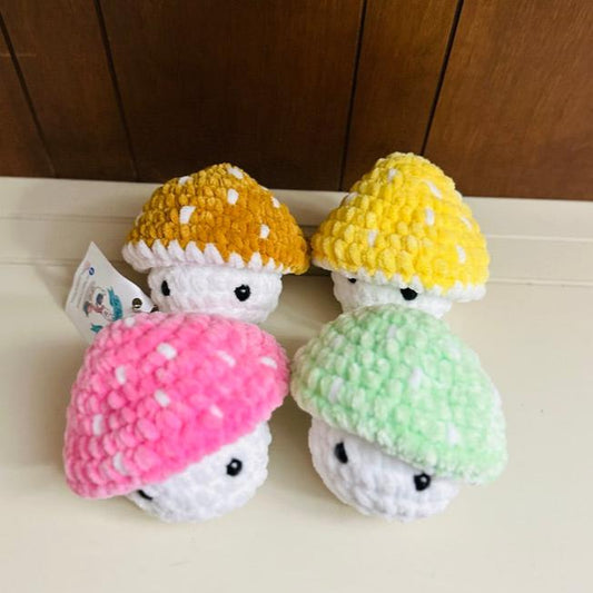 crochet mushroom in pink, green, gold and yellow
